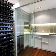 View of contemporary kitchen with white cabinetry, wooden cabinetry, countertop, flooring, interior design, kitchen, room, gray