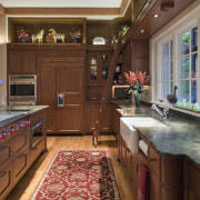 View of kitchen with wooden cabinetry and red cabinetry, countertop, cuisine classique, estate, interior design, kitchen, room, brown