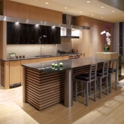 View of contemporary kitchen with wooden features and cabinetry, countertop, floor, flooring, hardwood, interior design, kitchen, laminate flooring, table, wood, wood flooring, orange, brown