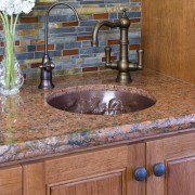 View of kitchen with wooden flooring and island cabinetry, countertop, floor, flooring, granite, hardwood, interior design, kitchen, sink, tile, wall, wood stain, brown