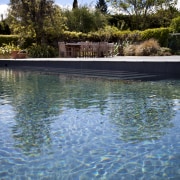 View of pool and landscaping. - View of body of water, lake, leisure, nature, plant, pond, reflection, reservoir, sky, swimming pool, tree, water, water feature, water resources, teal