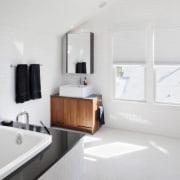 View of white bathroom with small wooden vanity bathroom, bathroom accessory, floor, interior design, product design, room, sink, tap, white