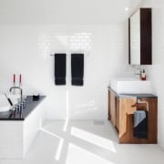 View of white bathroom with small wooden vanity bathroom, bathroom accessory, floor, interior design, plumbing fixture, product design, room, sink, tap, white