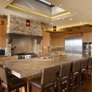 View of kitchen with wooden flooring, stone wall cabinetry, ceiling, countertop, cuisine classique, flooring, hardwood, interior design, kitchen, real estate, room, wood flooring, brown, orange