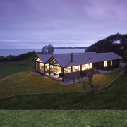 View of house at dusk. - View of architecture, cloud, cottage, estate, farm, farmhouse, grass, highland, hill, home, house, land lot, landscape, mountain, property, real estate, rural area, sky, blue