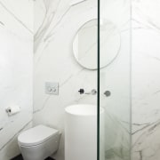 View of contemporary bathroom with marble walls. - architecture, bathroom, bathroom sink, bidet, ceramic, floor, interior design, plumbing fixture, product design, property, room, tap, tile, toilet, toilet seat, wall, white
