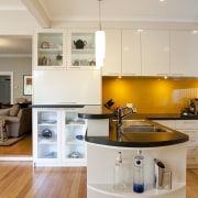View of contemporary kitchen with white cabinetry, island cabinetry, countertop, cuisine classique, floor, hardwood, home, interior design, kitchen, real estate, room, wood flooring, gray