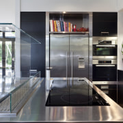 View of contemporary kitchen with stainless fridge and countertop, interior design, kitchen, gray, black