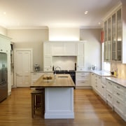 View of contemporary kitchen with wooden flooring and cabinetry, countertop, cuisine classique, floor, hardwood, interior design, kitchen, real estate, room, white