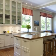 View of contemporary kitchen with wooden flooring and cabinetry, countertop, cuisine classique, floor, flooring, hardwood, interior design, kitchen, room, window, wood flooring, gray, brown