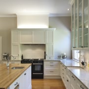 View of contemporary kitchen with wooden flooring and cabinetry, countertop, cuisine classique, floor, flooring, hardwood, home, interior design, kitchen, laminate flooring, real estate, room, wood flooring, gray