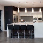 This home was designed and built by Signature floor, flooring, interior design, kitchen, real estate, room, gray, black