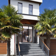 Here is a view of Sto European Plaster apartment, architecture, arecales, building, condominium, estate, facade, home, house, neighbourhood, palm tree, property, real estate, residential area, sky, villa