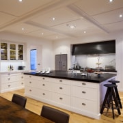 View of kitchen with wooden flooring, white cabinetry cabinetry, ceiling, countertop, cuisine classique, flooring, interior design, kitchen, real estate, room, wood flooring, gray