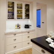 View of kitchen with wooden flooring, white cabinetry cabinetry, countertop, interior design, kitchen, room, gray