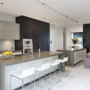 View of contemporary kitchen with light toned flooring, countertop, interior design, kitchen, real estate, gray