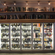 View of refrigeration solution at wine retailer. - bookcase, display case, liquor store, shelving, black