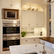 View of kitchen with white cabinetry and wooden cabinetry, countertop, cuisine classique, floor, home appliance, interior design, kitchen, room, orange, gray