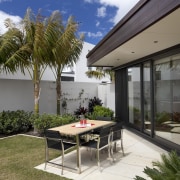 View of pool and patio area of contemporary architecture, arecales, backyard, courtyard, estate, home, house, outdoor furniture, outdoor structure, palm tree, patio, property, real estate, white, brown