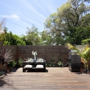 View of patio area with landscaping. - View arecales, backyard, estate, garden, home, house, landscape, landscaping, outdoor structure, patio, plant, property, real estate, residential area, tree, walkway, yard