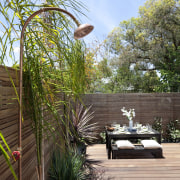 View of patio area with landscaping. - View arecales, backyard, home, landscape, landscaping, outdoor structure, palm tree, plant, real estate, tree, walkway, yard, brown