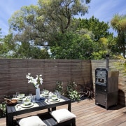 View of patio area with landscaping. - View backyard, deck, home, house, outdoor structure, patio, plant, property, real estate, tree, yard, black