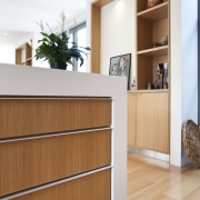 View of kitchen island drawers with wooden flooring. bookcase, cabinetry, chest of drawers, drawer, floor, flooring, furniture, hardwood, interior design, plywood, shelf, shelving, sideboard, wood, wood flooring, white, brown