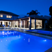 Outdoor night shot of contemporary house and pool architecture, estate, home, house, lighting, mansion, property, real estate, reflection, sky, swimming pool, villa, water, blue