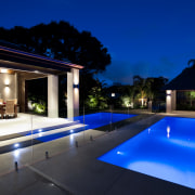 Outdoor night shot of contemporary house and pool architecture, backyard, estate, home, house, landscape lighting, leisure, lighting, property, real estate, resort, sky, swimming pool, villa, blue, black