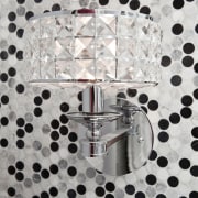 Close up of lamp with spotted wallcovering. - design, metal, pattern, product, gray