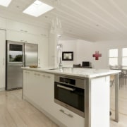 View of contemporary kitchen with light-toned flooring, ceiling countertop, floor, flooring, interior design, kitchen, product design, wood flooring, gray