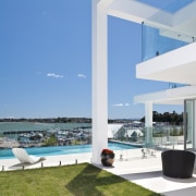 The site on which this contemporary house is apartment, architecture, condominium, estate, home, house, penthouse apartment, property, real estate, resort, swimming pool, teal