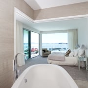 View of contemporary white tub in open plan architecture, bathroom, bathtub, daylighting, estate, floor, home, interior design, plumbing fixture, real estate, room, suite, gray, white