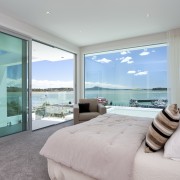 Bathroom with grey carpeting and light toned bedspread bedroom, ceiling, condominium, estate, home, interior design, penthouse apartment, property, real estate, room, window, gray