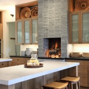 Kitchen with fireplace and island with white benchtops countertop, fireplace, flooring, hearth, interior design, kitchen, white, brown