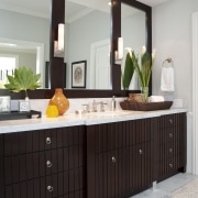 View of brown cabinetry with three rectangular mirrors. bathroom, bathroom accessory, bathroom cabinet, cabinetry, countertop, home, interior design, kitchen, room, sink, gray, black