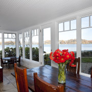 Dining room with wooden table and chairs and estate, home, house, interior design, living room, porch, real estate, window, gray