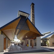 View of outdoor seating area. - View of architecture, building, house, roof, blue