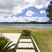 View of pool and patio area of contemporary arecales, cloud, grass, landscape, palm tree, sea, shore, sky, tree, tropics, vacation, water, white