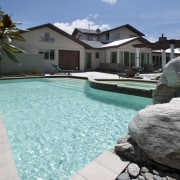 View of contemporary house with pool. - View estate, home, house, leisure, property, real estate, resort, swimming pool, villa, water, teal, black