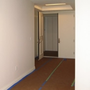 Hallway with door. - Hallway with door. - apartment, ceiling, floor, flooring, hardwood, home, house, interior design, laminate flooring, property, real estate, room, wall, wood, wood flooring, wood stain, gray, brown