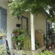 Before shot of entrance with pots of plants. backyard, cottage, courtyard, home, house, outdoor structure, plant, porch, property, real estate, window, yard, brown