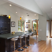 Kitchen with wooden flooring, dark toned island and ceiling, countertop, floor, flooring, hardwood, home, interior design, kitchen, property, real estate, room, wood flooring, gray