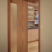 Sliding door that wraps around to close. kitchen cabinetry, closet, cupboard, door, wood, wood stain, orange, brown