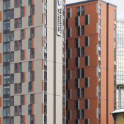 View of exterior with orange wall. - View apartment, architecture, building, commercial building, condominium, corporate headquarters, facade, house, mixed use, neighbourhood, real estate, residential area, tower block, urban area, gray