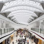 View of light toned interior of mall. - architecture, building, daylighting, metropolitan area, mixed use, shopping mall, tourist attraction, white, gray