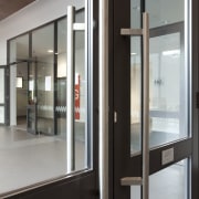 View of door handle. - View of door door, glass, window, gray, black