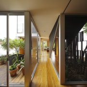 Hallway with wooden flooring and view out to architecture, daylighting, door, floor, flooring, hardwood, home, house, interior design, real estate, window, wood, wood flooring, brown