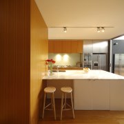 Kitchen with wooden cupboards, white island stainless fridge. architecture, cabinetry, ceiling, countertop, interior design, kitchen, room, table, brown, orange