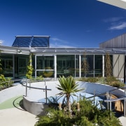 View of outdoor walkway with landscaping. - View apartment, architecture, corporate headquarters, estate, home, house, mixed use, property, real estate, resort, roof, swimming pool, villa, window, blue